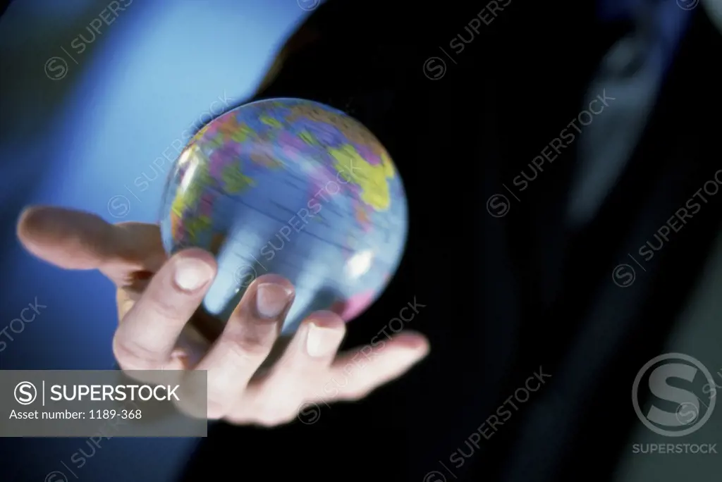 Close-up of a businessman holding a globe