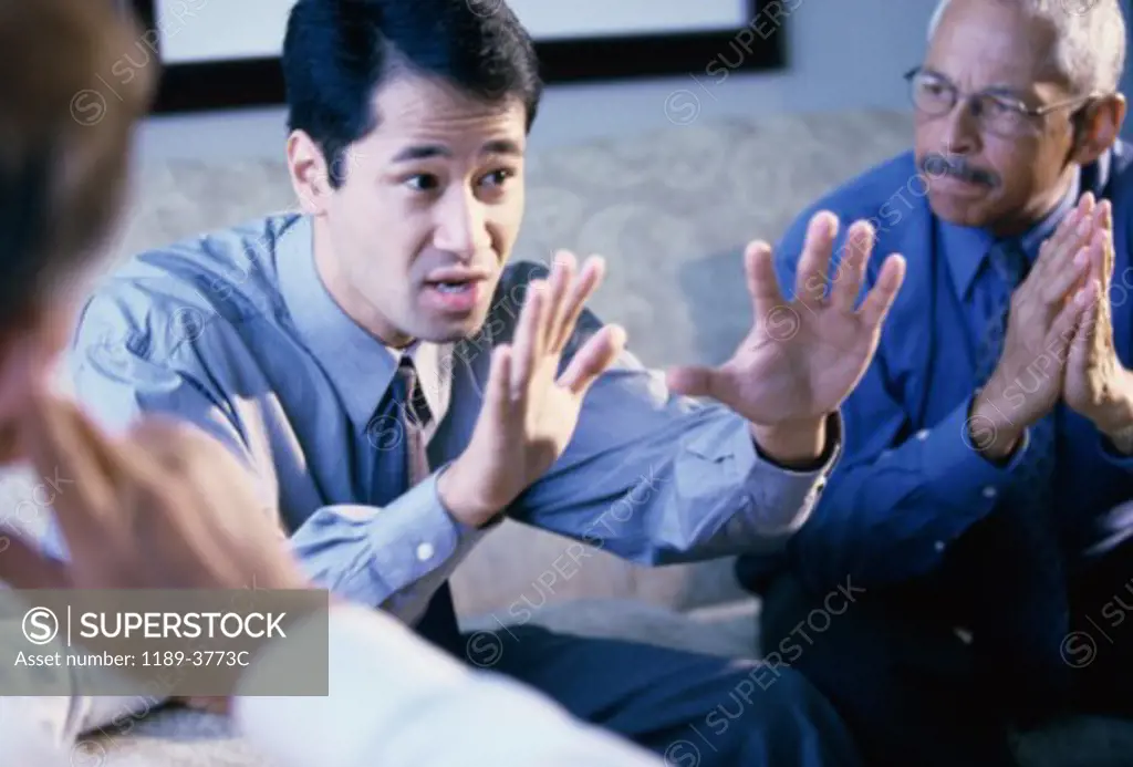 Three businessmen talking in an office