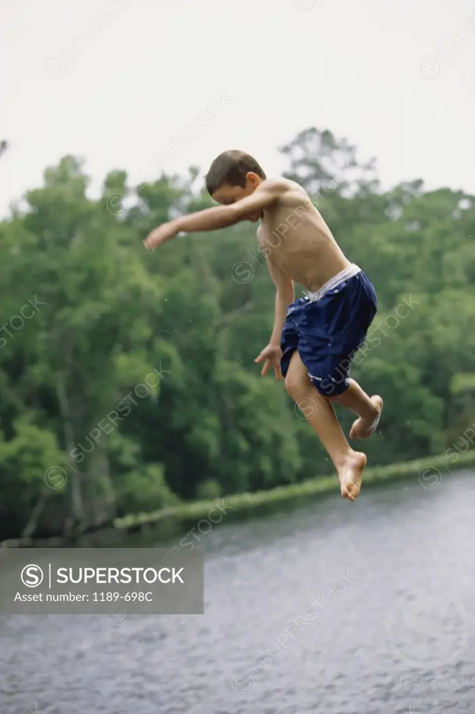 Side profile of a boy jumping into water