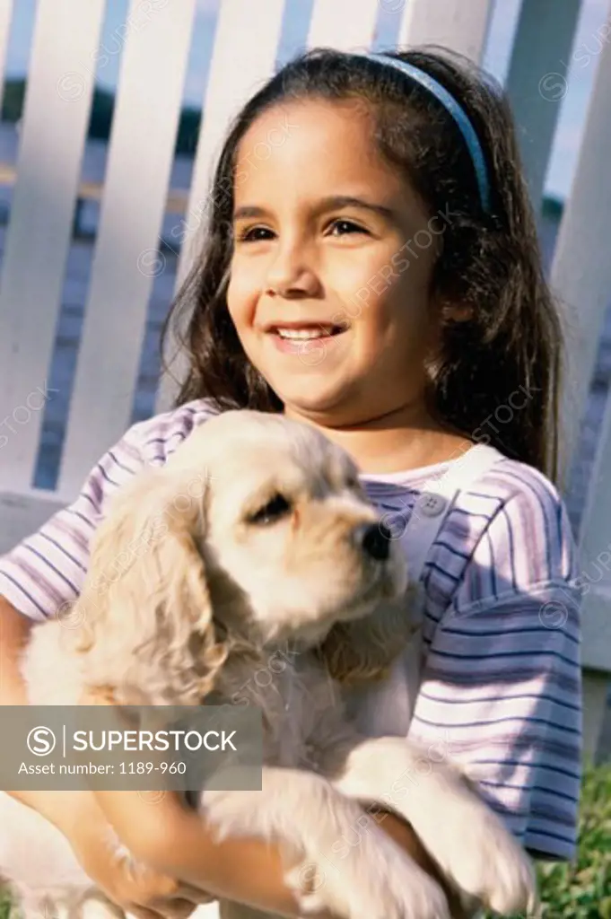 Close-up of a girl holding her puppy