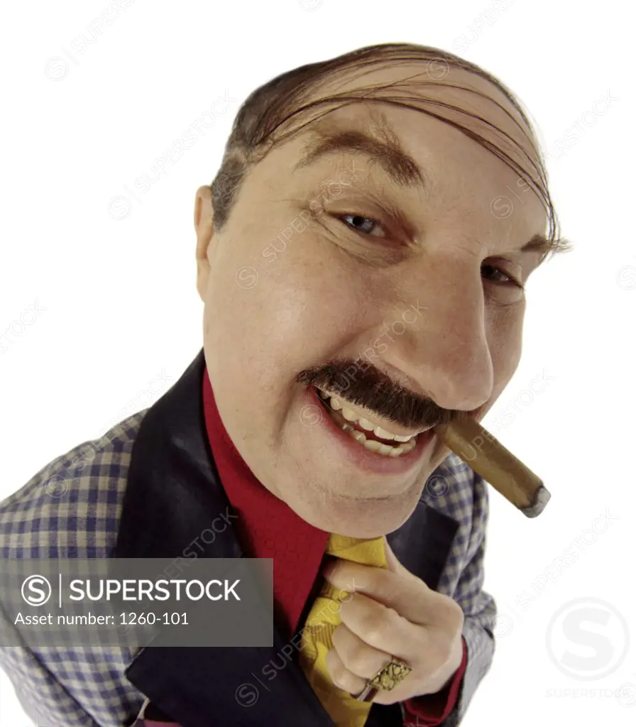 Close-up of an eccentric man smoking a cigar while adjusting his tie