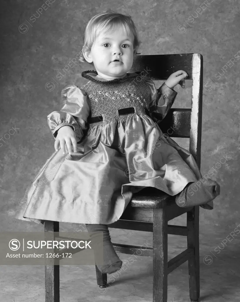 Portrait of a baby girl sitting on a chair