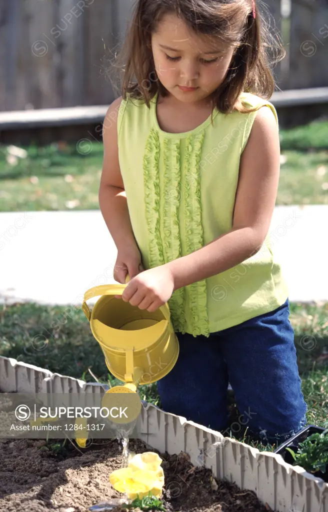 Girl watering plants,