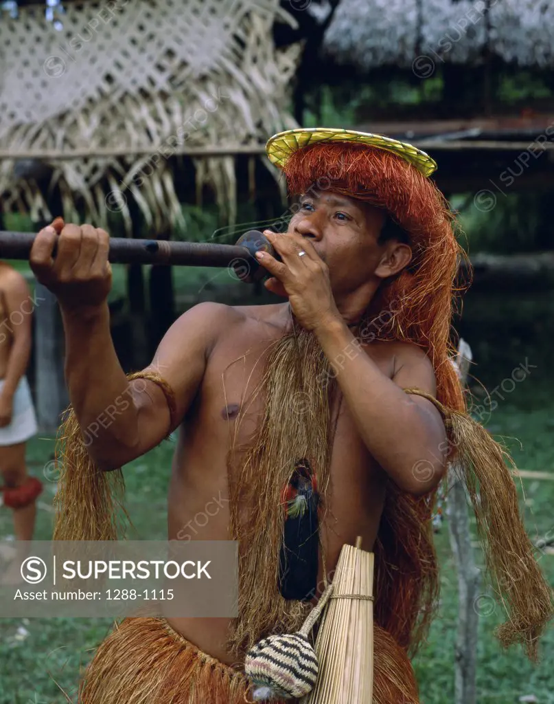 Yagua Indian man using a blowpipe, Peru