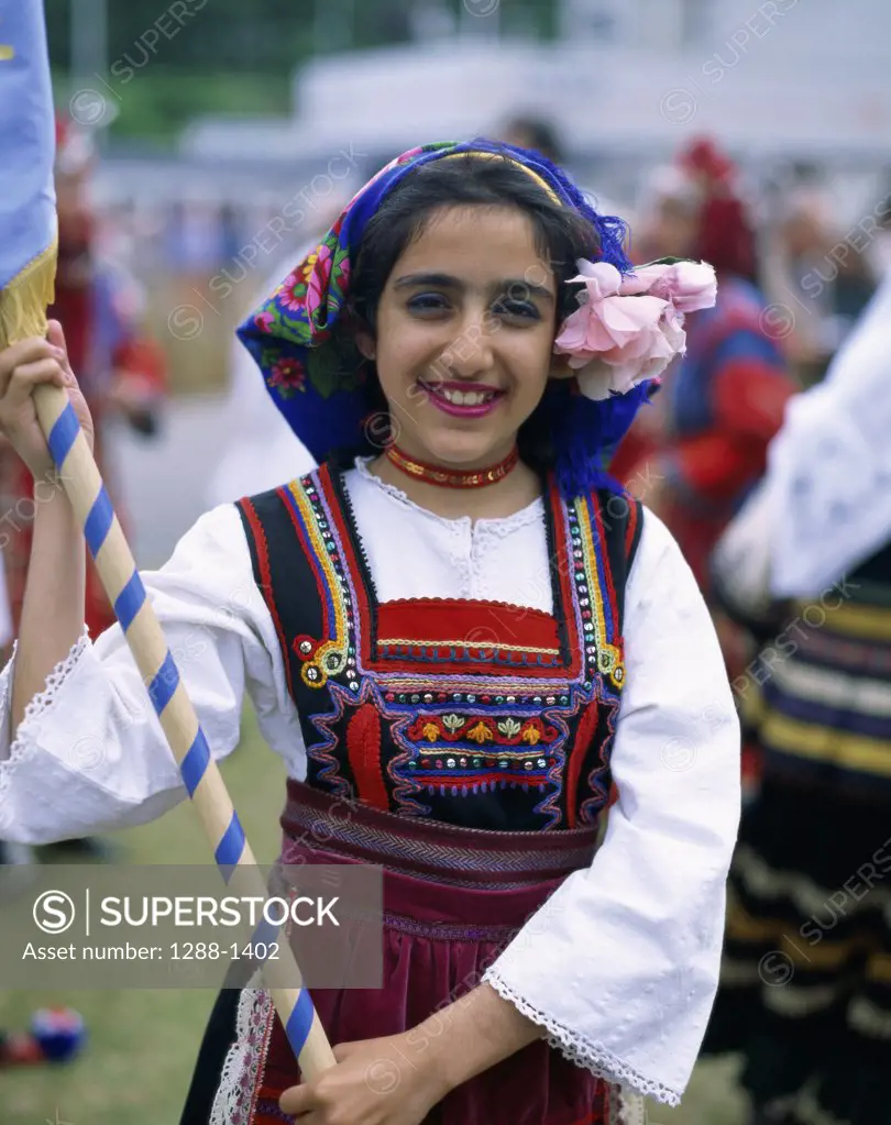 Portrait of a teenage girl wearing a traditional costume smiling, Greece