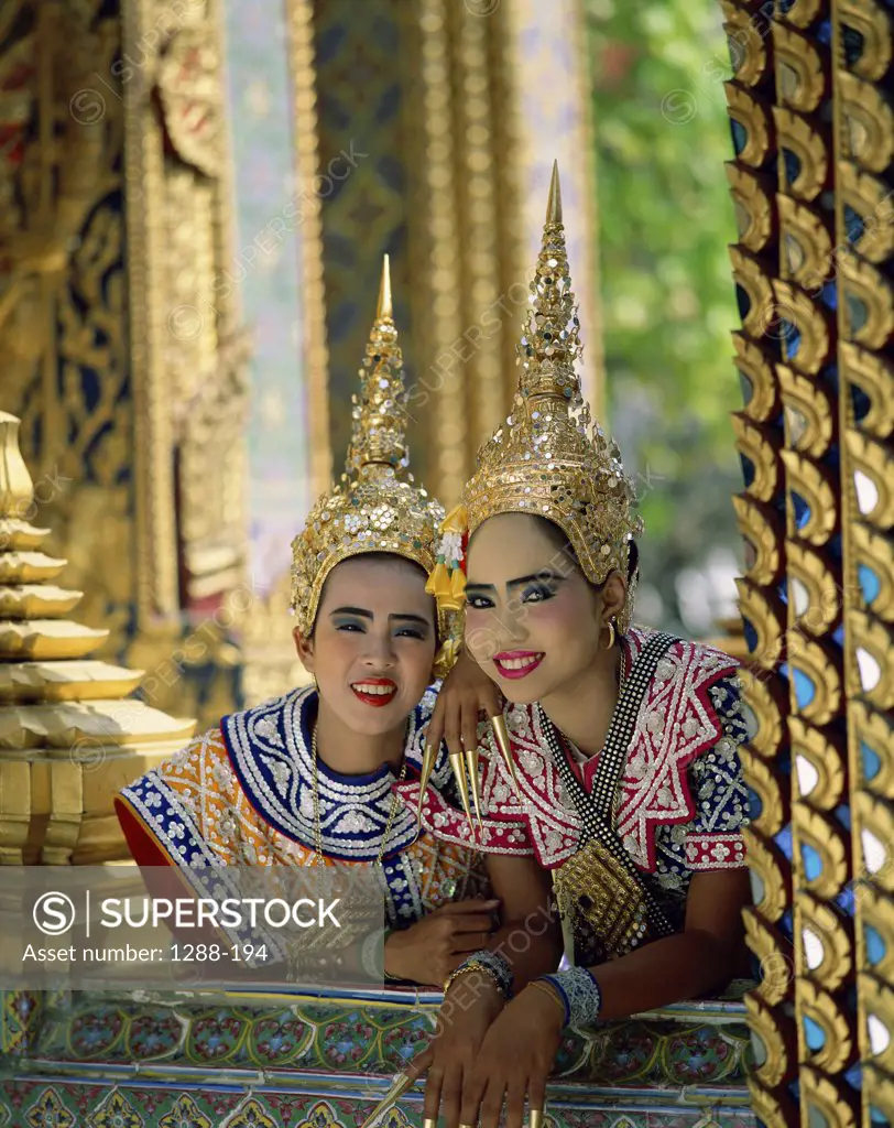 Portrait of two young women in traditional clothing, Thailand