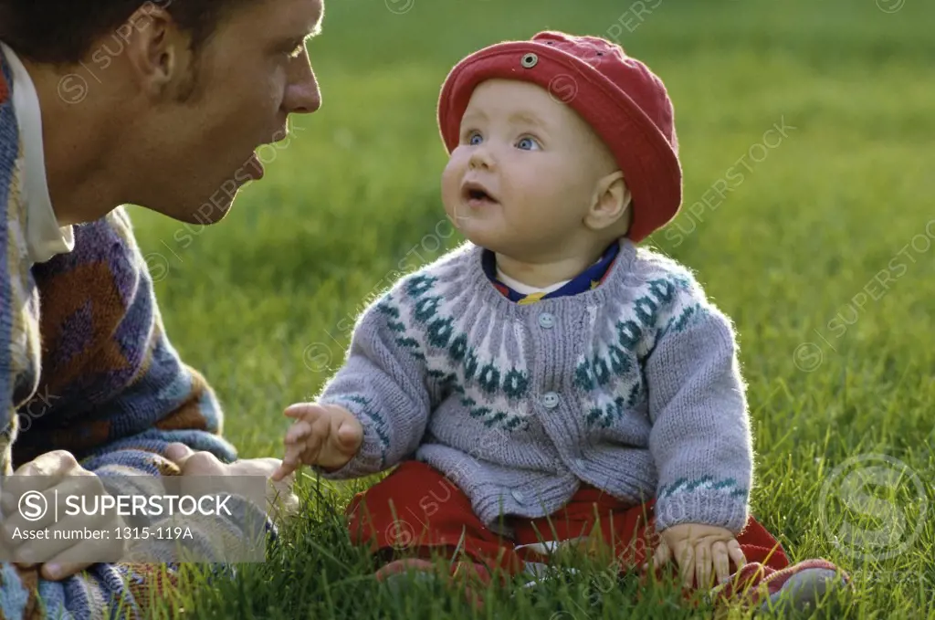 Close-up of a father talking to his daughter