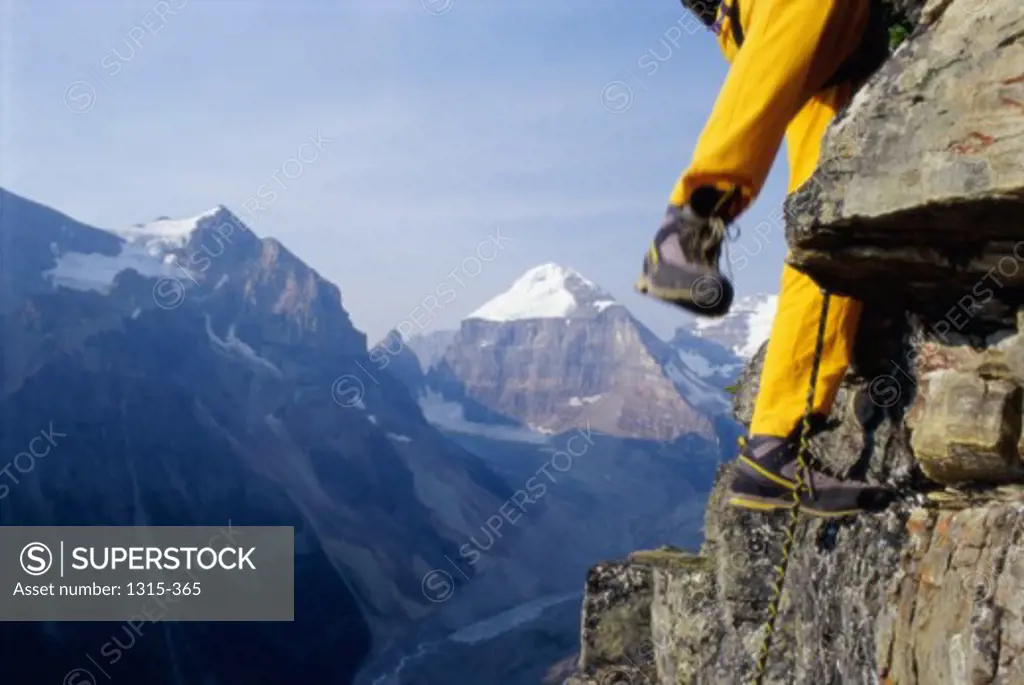 Low section view of a person climbing a rock face, Banff, Alberta, Canada