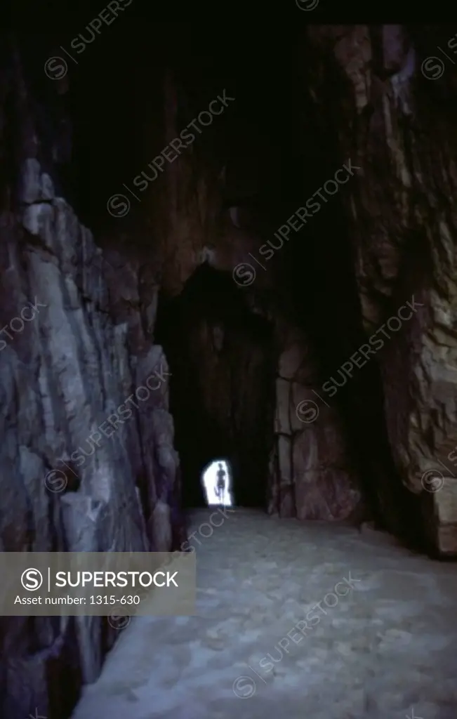 Silhouette of a person standing at the entrance of a tunnel, Cabo San Lucas, Mexico