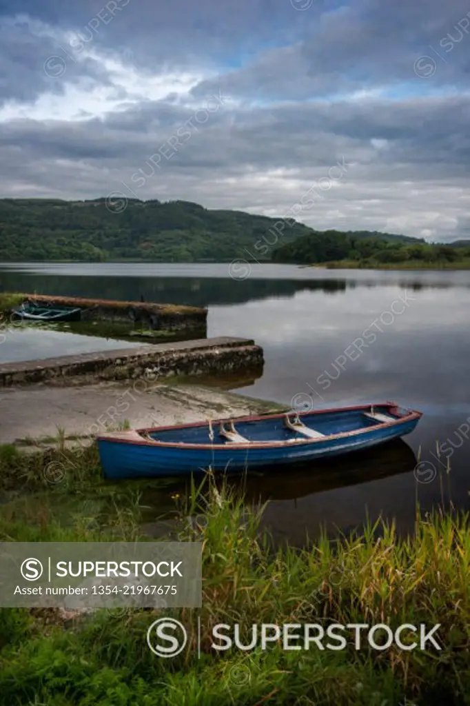 tranquil Inchaquin Lake with boat in Co Clare, Ireland 