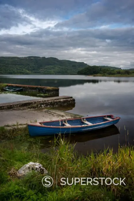 tranquil Inchaquin Lake with boat in Co Clare, Ireland 