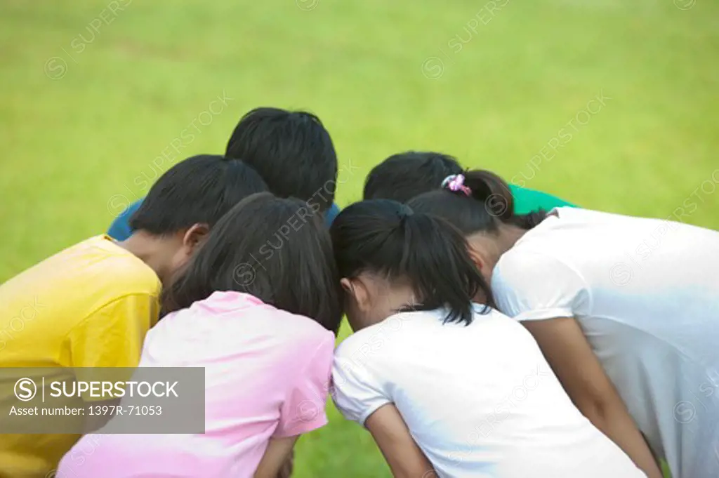 Group of children discussing in huddle