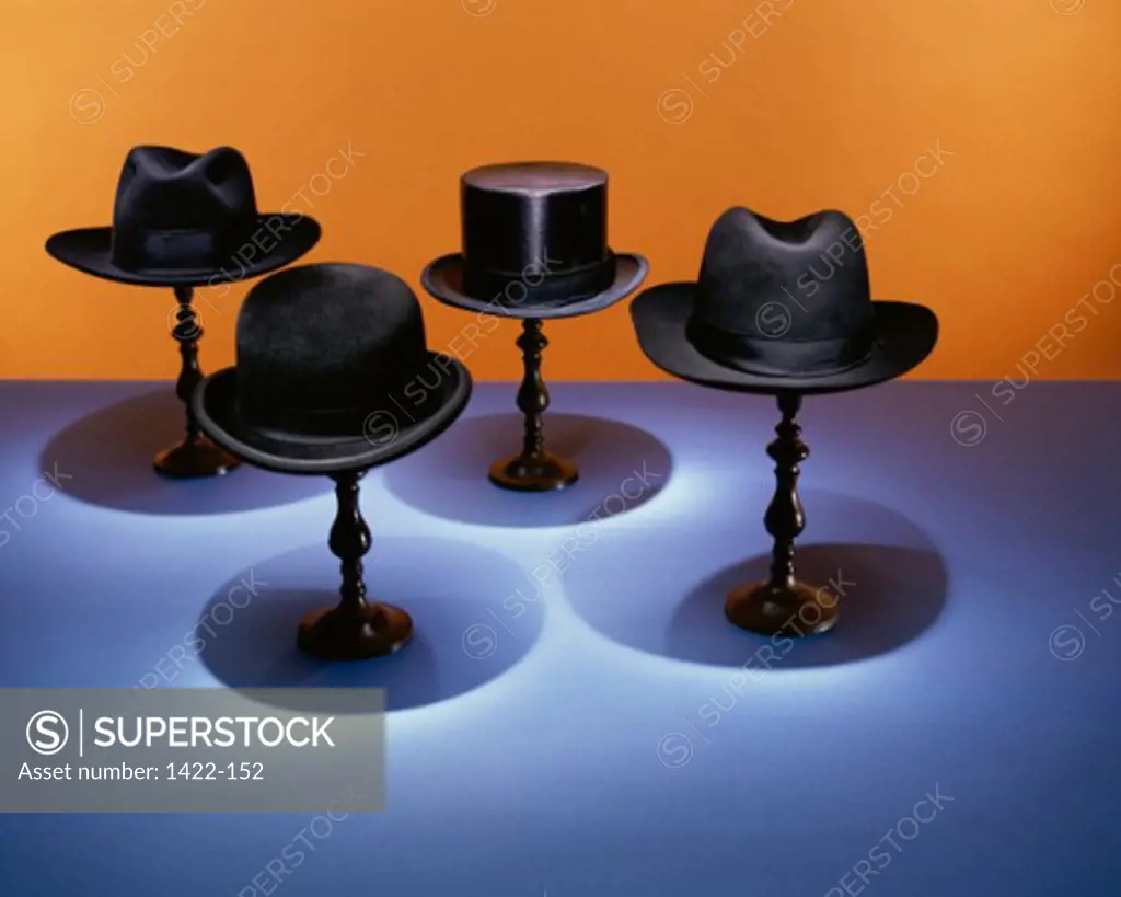 Close-up of four hats on display