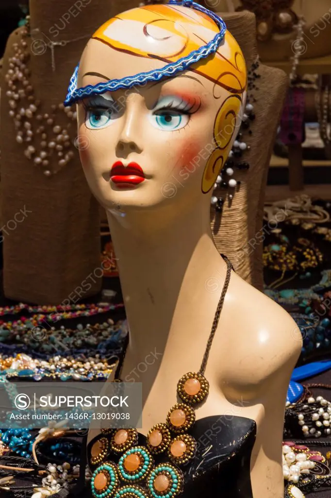 A painted mannequin head wearing jewelry at a booth at the Pasadena Flea Market, Pasadena, California.