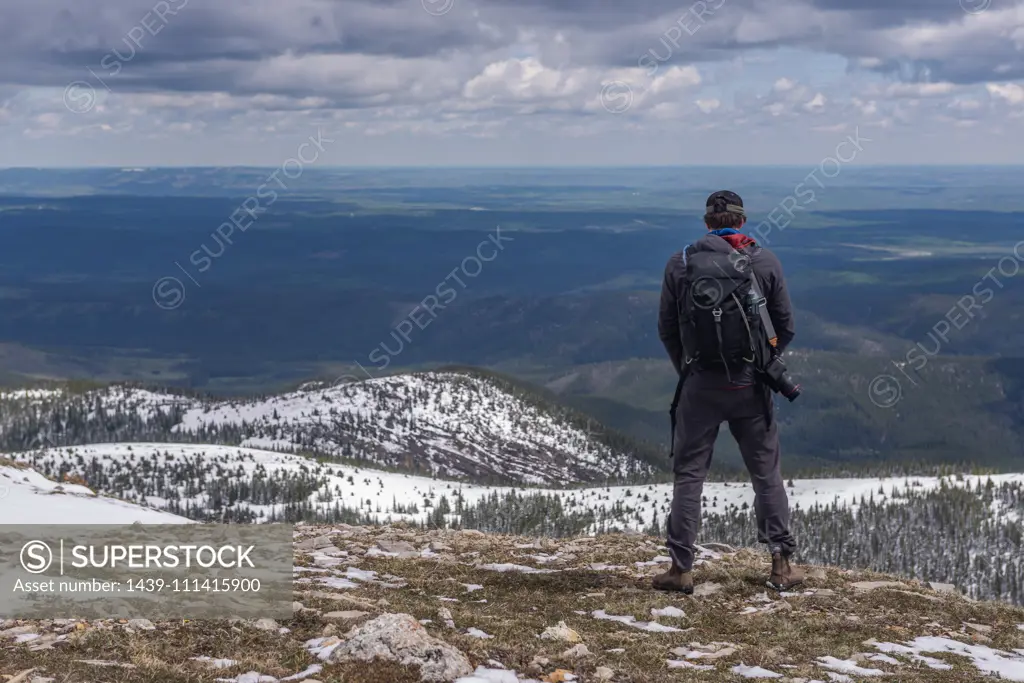 Hiker on top of mountain range, Calgary, Canada