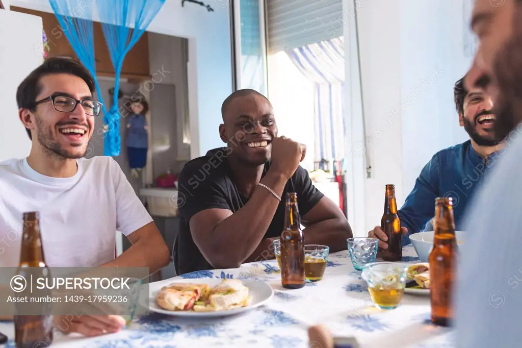 Male friends socialising with food and beer