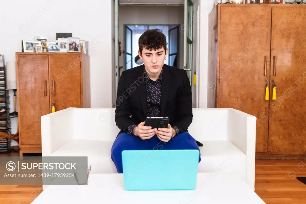 Young man working on laptop at home