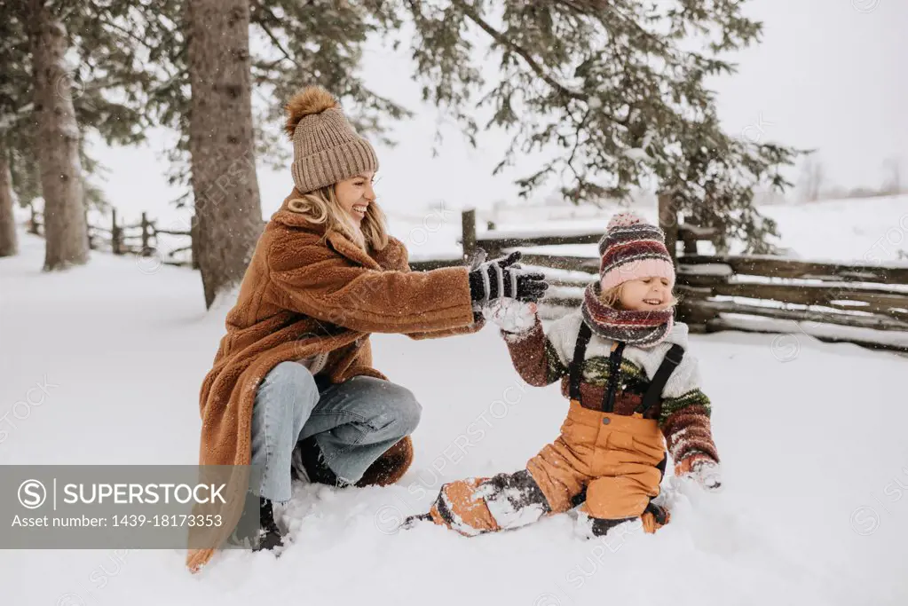 Canada, Ontario, Mother and daughter playing in snow