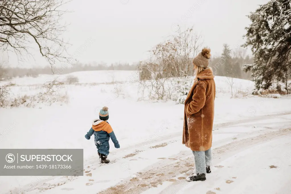 Canada, Ontario, Mother and son on snowy road