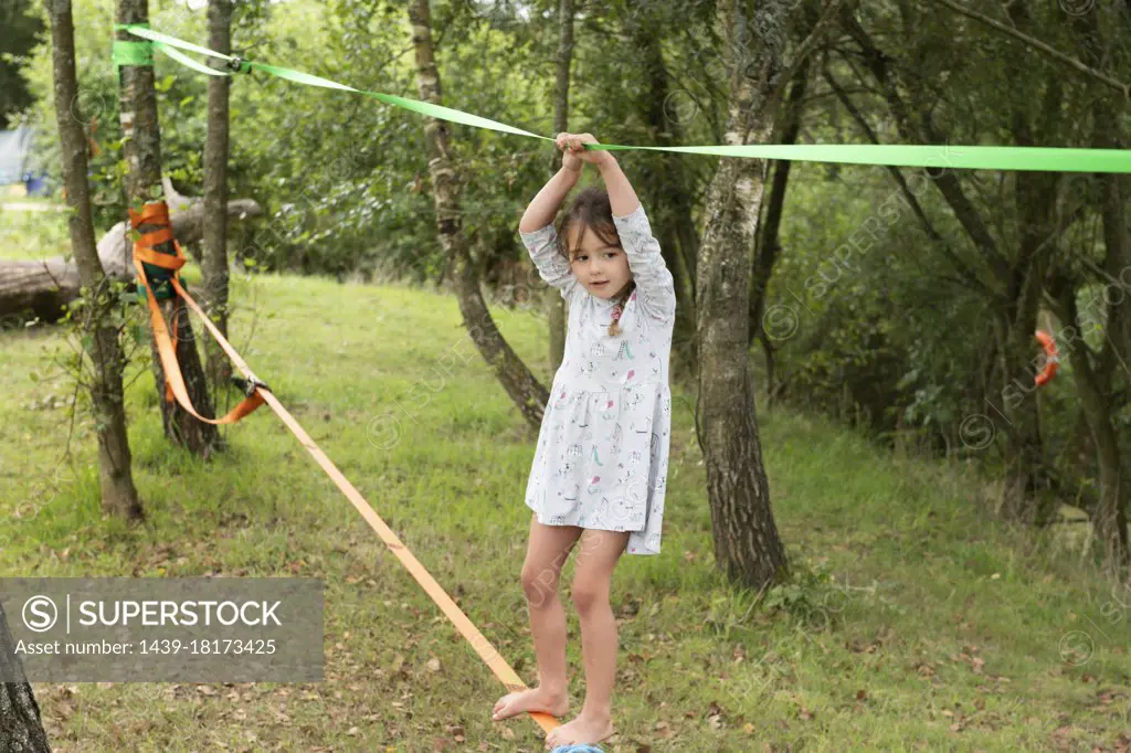 UK, Girl on slackline in park