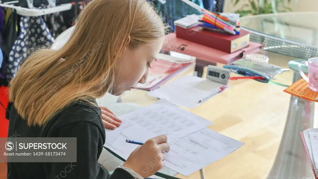 UK, Surrey, Girl doing homework