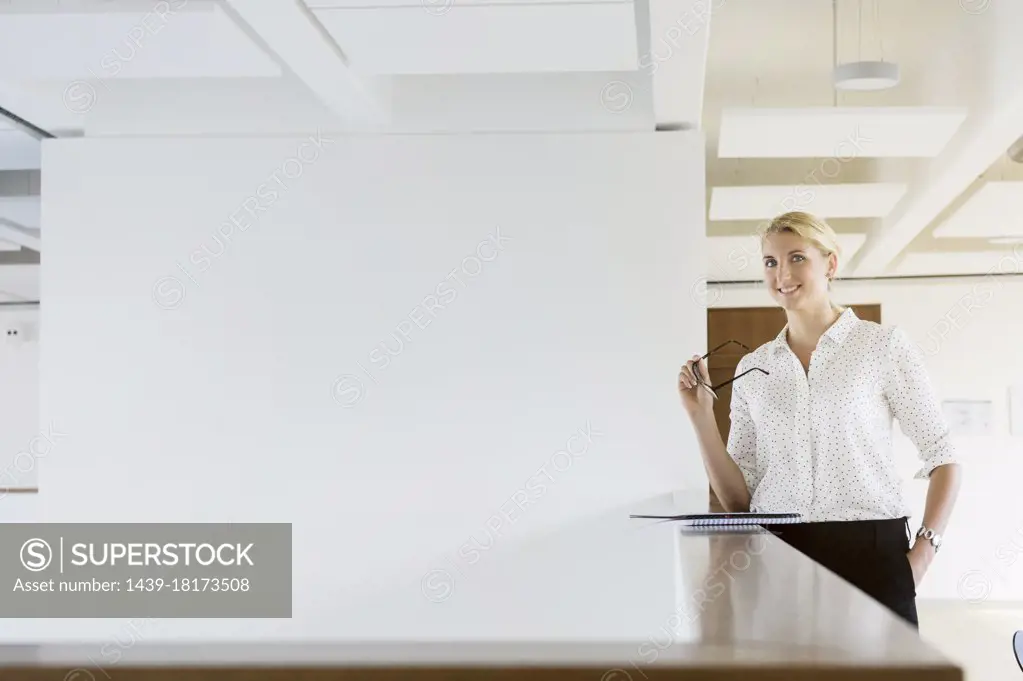 Germany, Bavaria, Munich, Portrait of young businesswoman standing in office