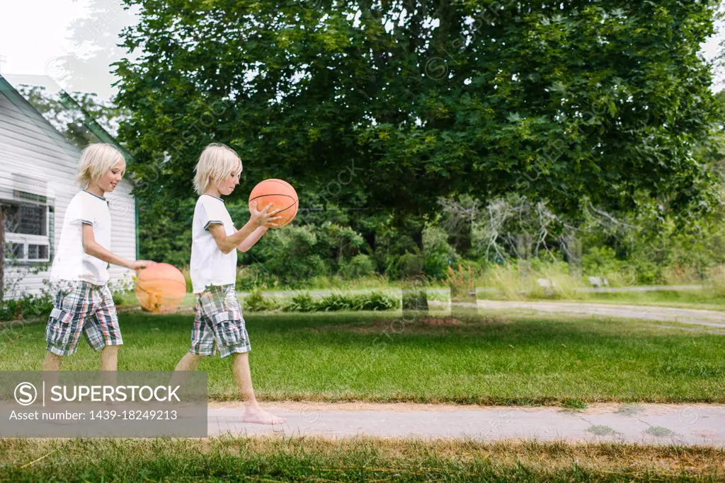 Canada, Ontario, Multiple exposure of boy (8-9) with basketball ball outdoors