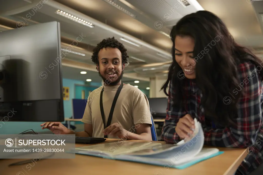 Students using computer in library