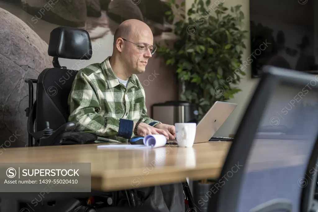 Disabled businessman working on his computer.