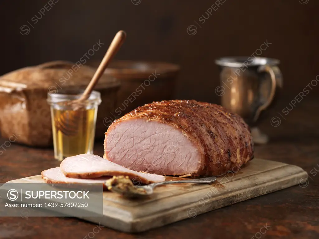 Christmas dinner. Honey and wholegrain mustard gammon on chopping board