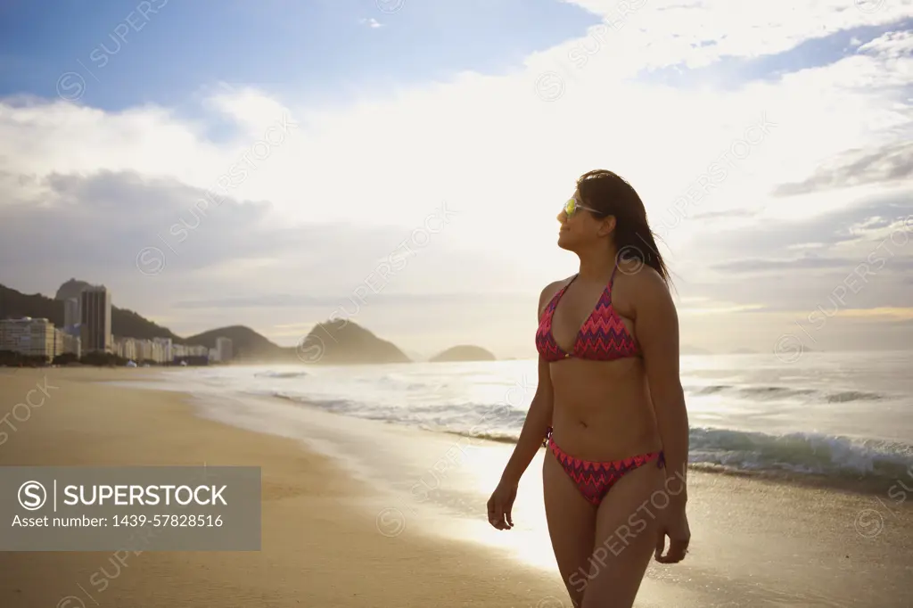 Mature woman strolling on Copacabana beach, Rio De Janeiro, Brazil