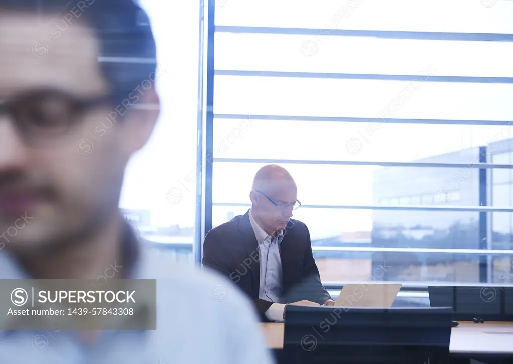 Window view of businessmen working in office