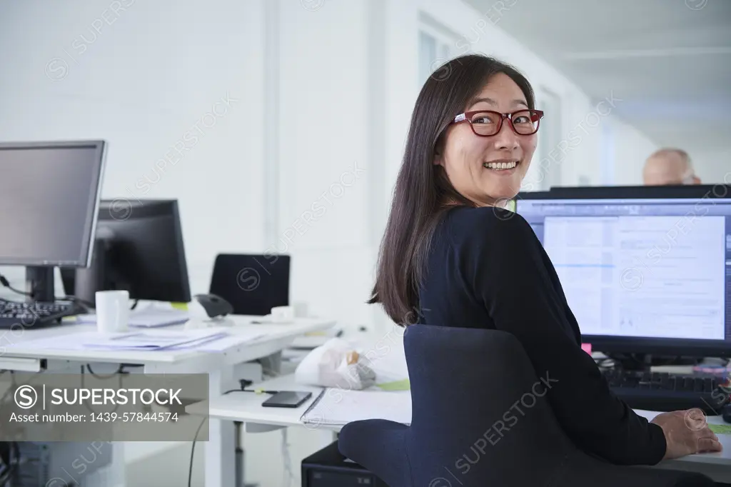 Woman working in office, using computer