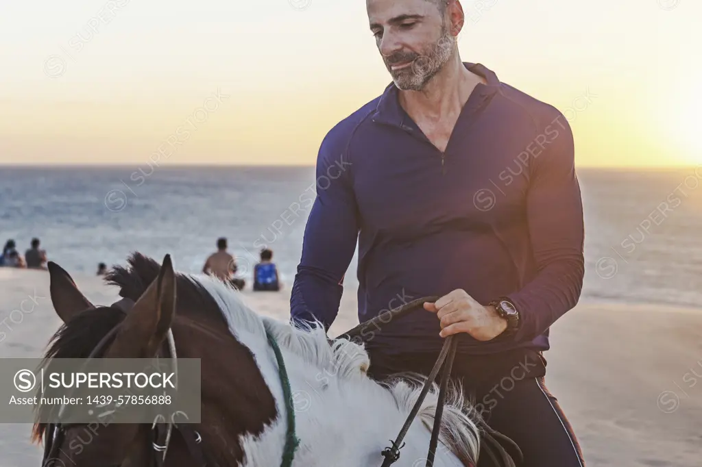 Man riding horse on beach, Jericoacoara, Ceara, Brazil, South America