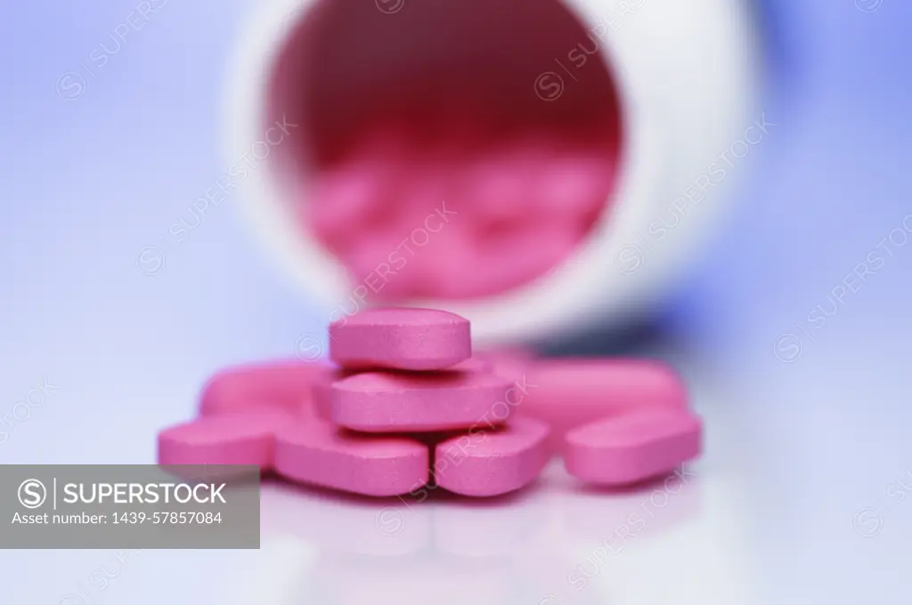 Pink 25mg Diphenhydramine antihistamine pills from medicine bottle