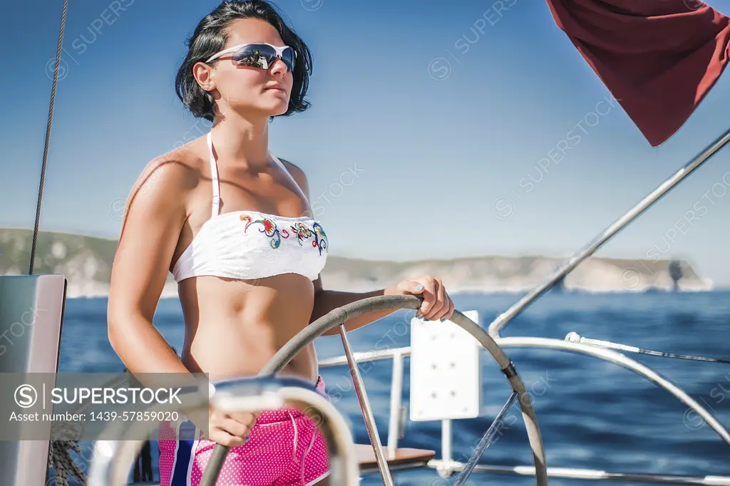 Woman in bikini steering boat, Koralat, Zagrebacka, Croatia