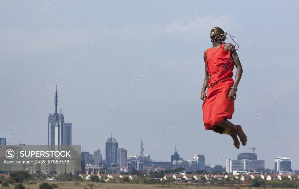 Masai warrior jumping in mid air during traditional dance, Nairobi, Kenya, Africa