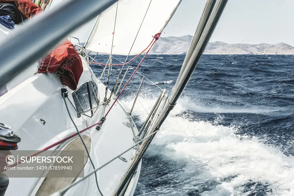 Aboard view of yacht sailing through ocean waves near coast, Croatia