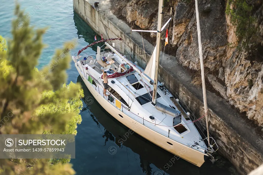 High angle portrait of man waving from yacht, Croatia