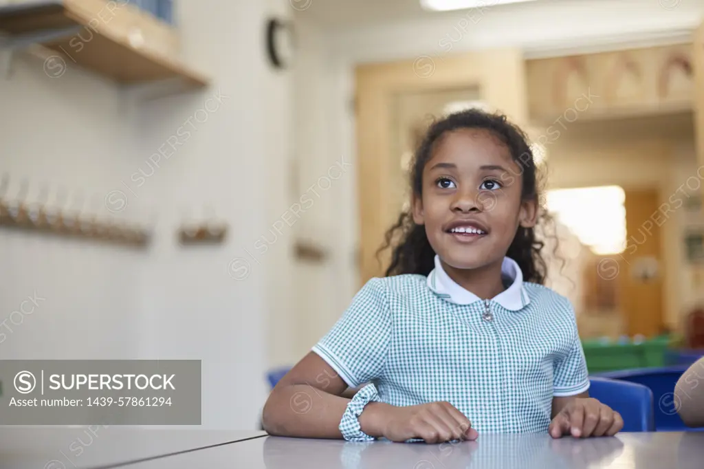 Young girl smiling in classroom environment