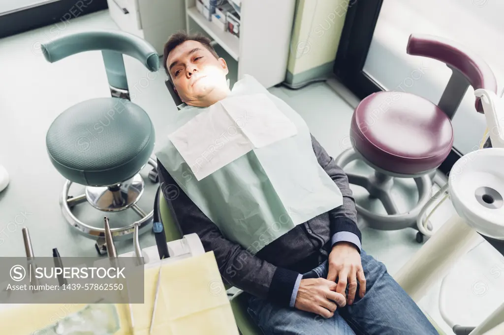 Male patient in dentist chair, elevated view