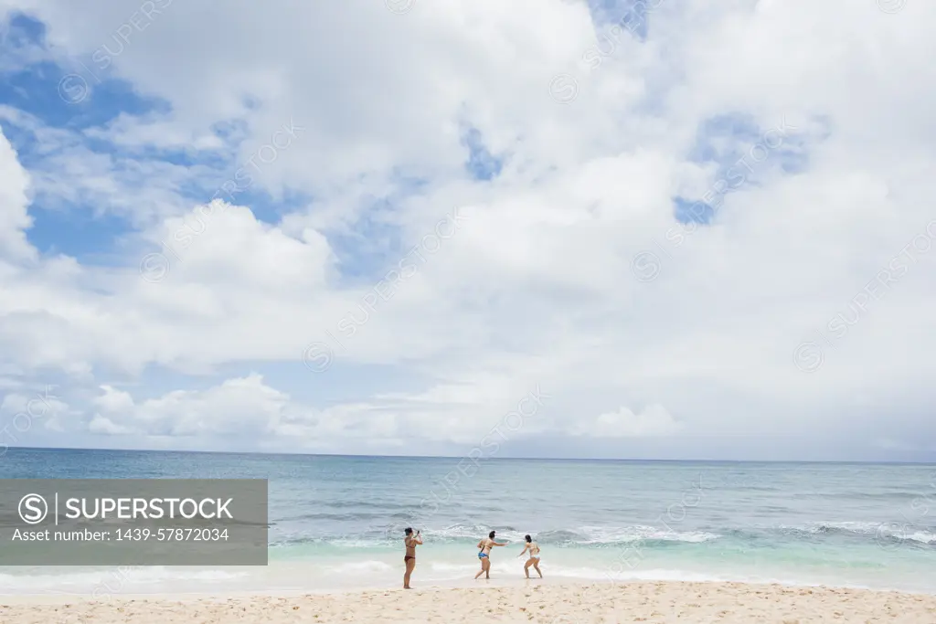 Friends enjoying Sunset Beach, Oahu, Hawaii