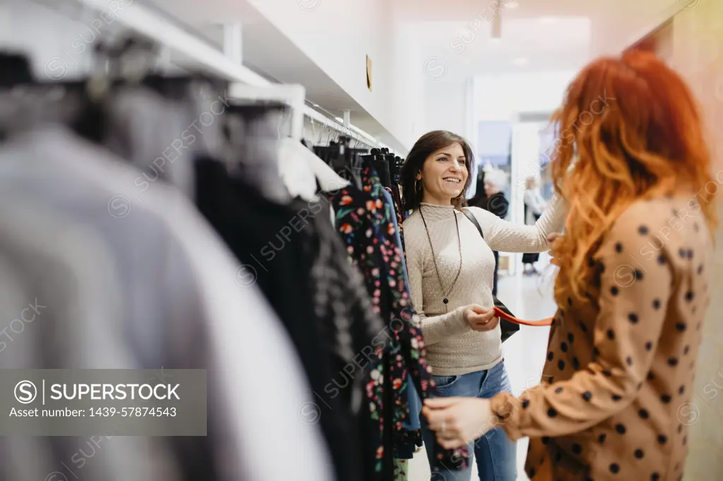 Girlfriends shopping in fashion boutique