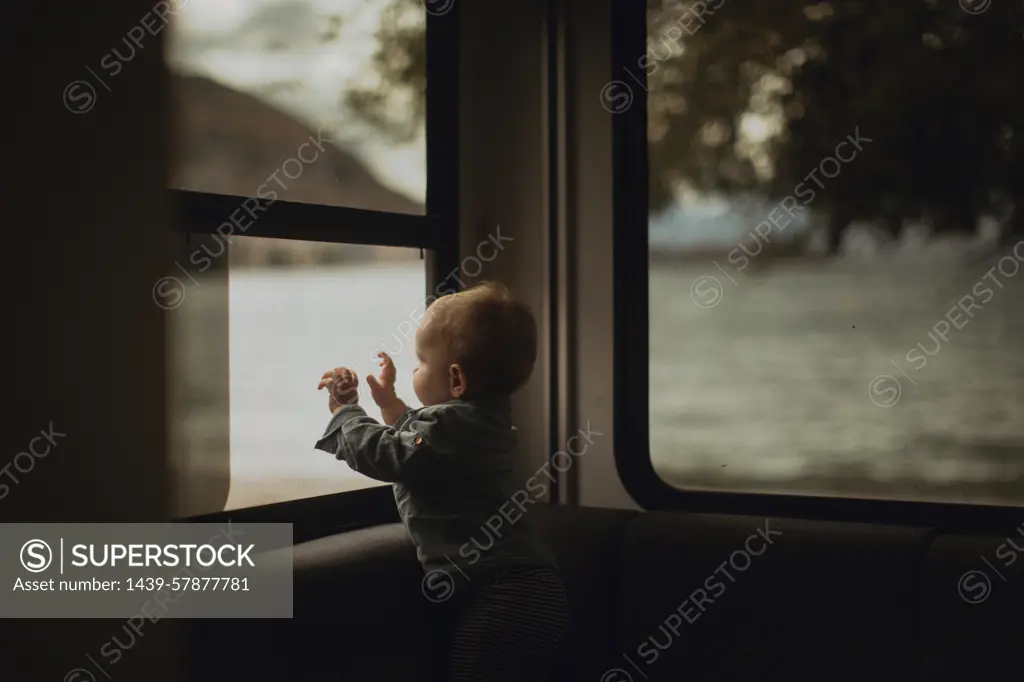 Baby looking out window of motorhome, Wanaka, Taranaki, New Zealand