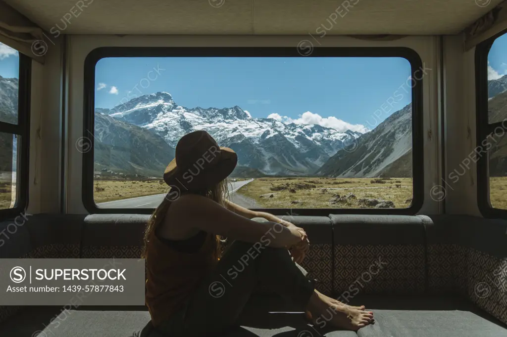 Woman enjoying view from inside motorhome, Wanaka, Taranaki, New Zealand