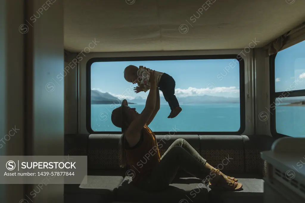 Mother playing with baby in motorhome, Wanaka, Taranaki, New Zealand