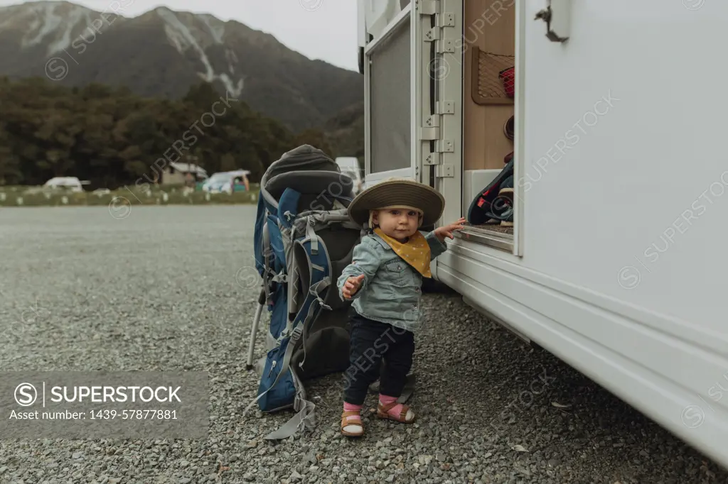 Baby hiker posing beside motorhome, Queenstown, Canterbury, New Zealand