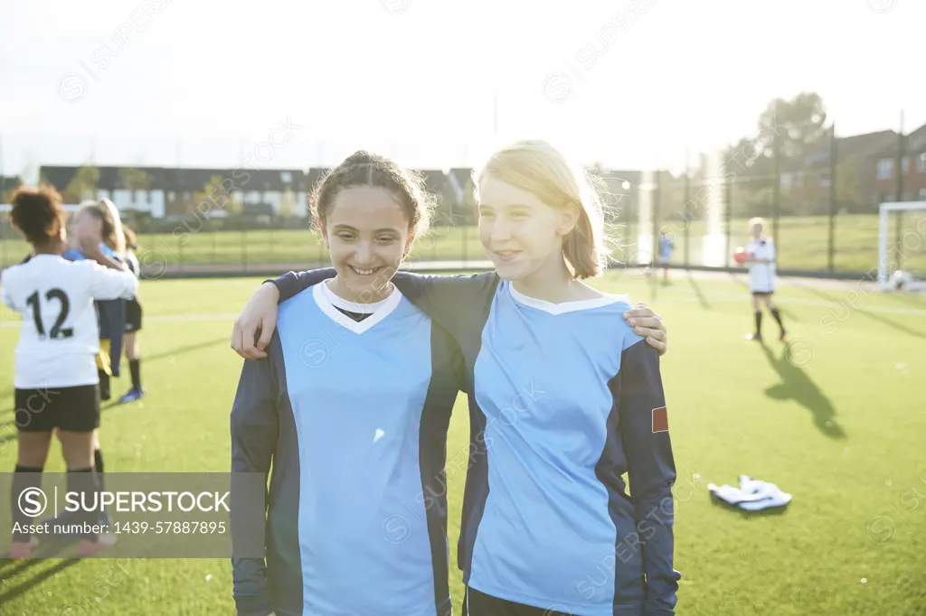 Two young soccer players sharing a moment on the field