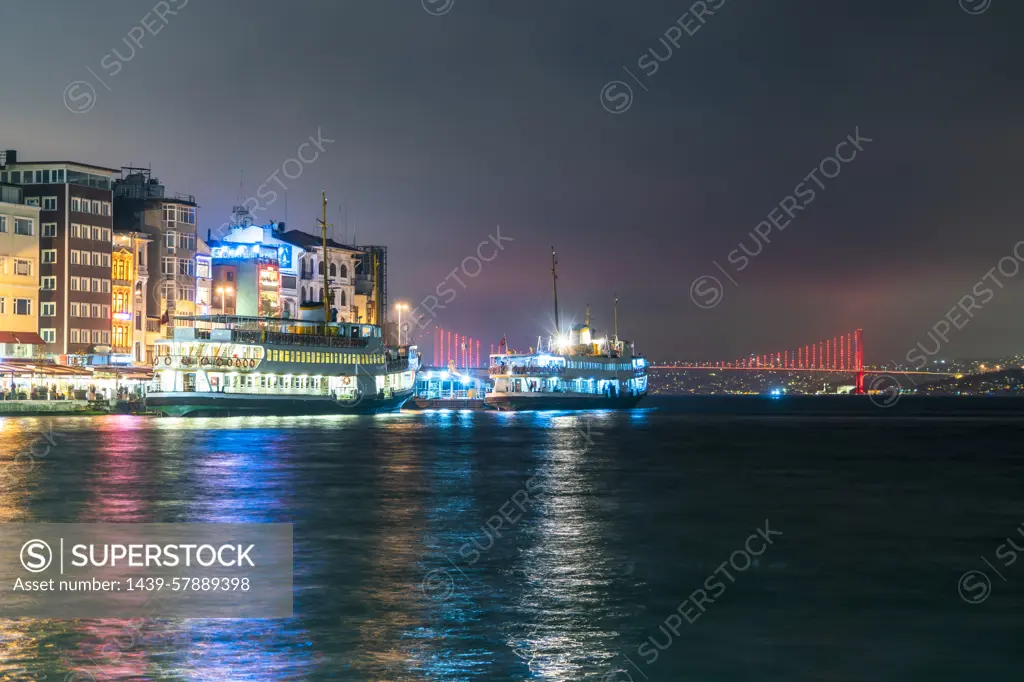 Turkey, Istanbul, Illuminated tour boats at night