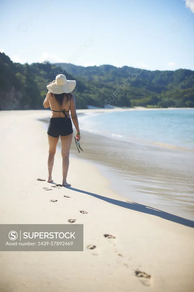 Woman on New Chums beach, Coromandel Peninsula, New Zealand